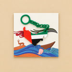 Load image into Gallery viewer, ميدالية خريطة الإمارات بسلسلة خضراء ليوم العلم مع البطاقة التراثية، تصوير علوي على خلفية بيج